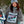 Person wearing oversized tshirt with 'Girls Can Board Too' text in a snowy outdoor setting