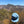 Blue cap on a bush with mountains in the background